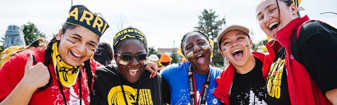 students in bright clothes smile and laugh