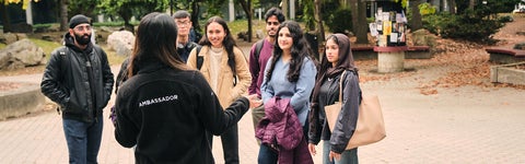 Students listen to a Waterloo student ambassador during a campus tour
