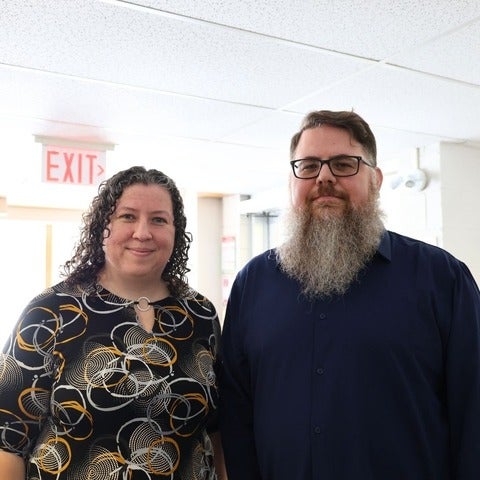 two people standing and smiling