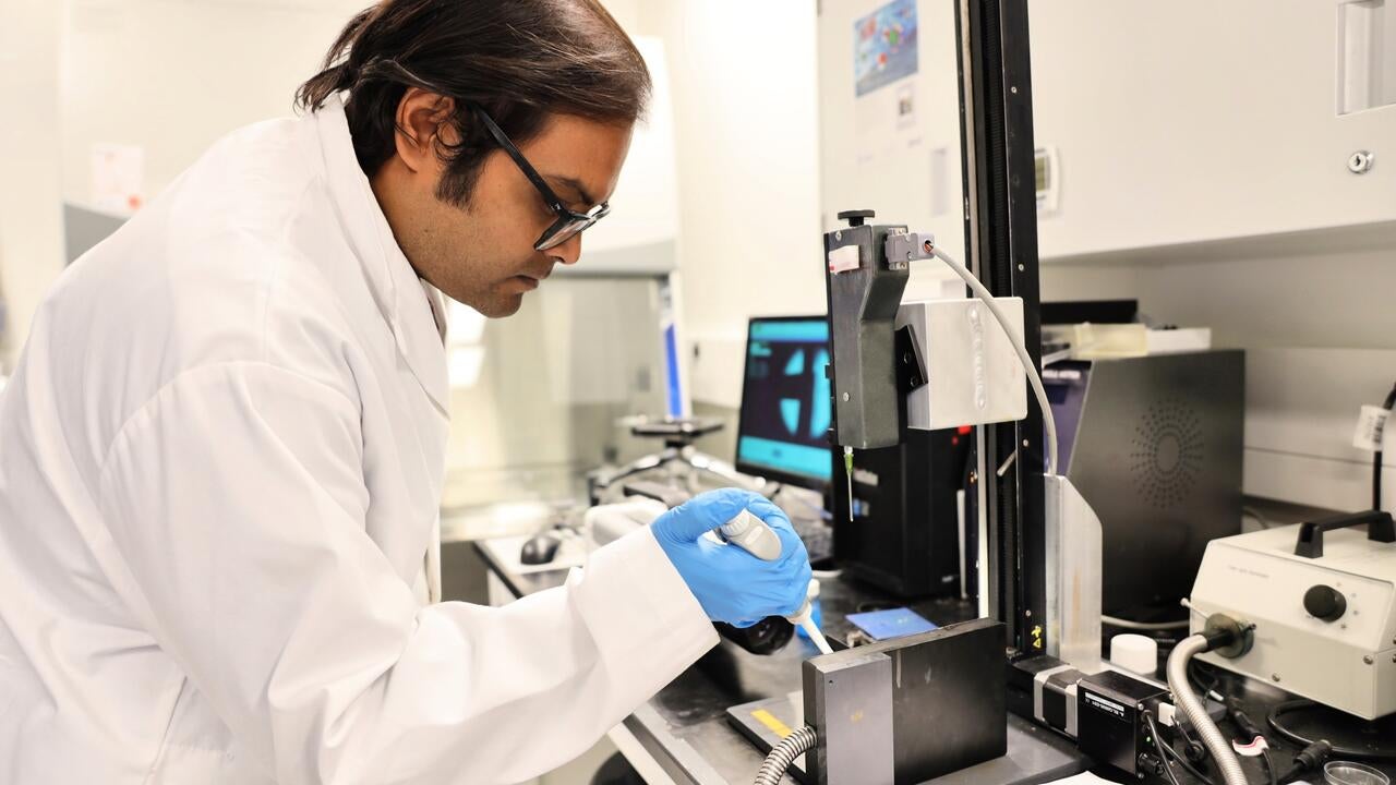 Dr. Surjyasish Mitra, a member of the Waterloo research team, dispenses a soft sphere on a vertical surface